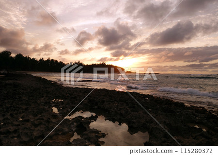 Sunset through the clouds and reflecting Sunset through the clouds and reflecting 115280372