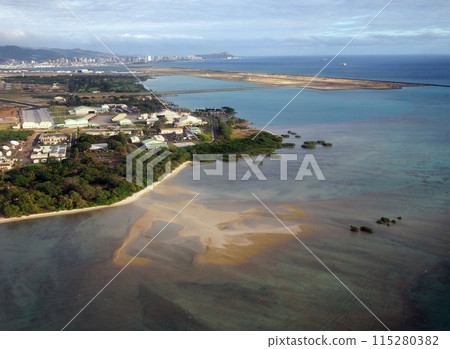 Honolulu International Airport and Coral reef Runway seen from the air with surrounding water and Honolulu city in the distance Honolulu International Airport and Coral reef Runway seen from the air with surrounding water and Honolulu city in the distance 115280382