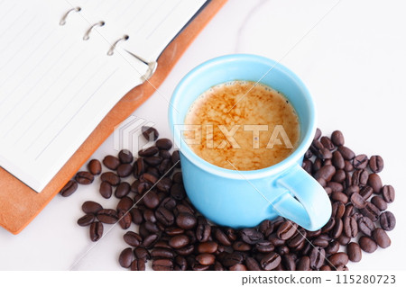 Cafe latte, a coffee made by adding a lot of milk to espresso, and dark roasted coffee beans Cafe latte, a coffee made by adding a lot of milk to espresso, and dark roasted coffee beans 115280723