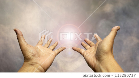 Two hands reaching for something the light in the haze. Two hands reaching for something the light in the haze. 115280737