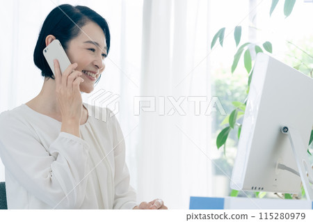 Business woman talking on a smartphone Business woman talking on a smartphone 115280979