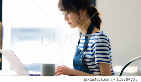 Female cafe owner who counts sales Female cafe owner who counts sales 115284755