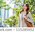 Businesswoman walking outdoors: Career advancement image: Summer sun protection image 115285052
