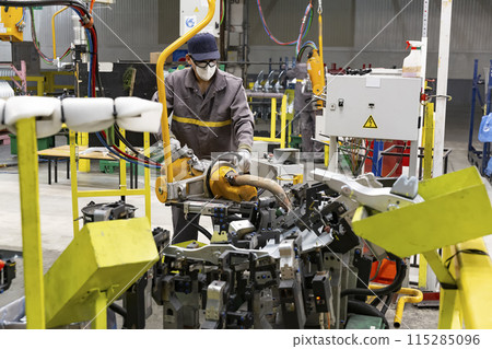 Industrial production of car automobiles. Plant for assembling modern cars on an assembly line. Industry, production, industry concept. 115285096
