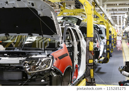 Industrial production of car automobiles. Plant for assembling modern cars on an assembly line. Industry, production, industry concept. Industrial production of car automobiles. Plant for assembling modern cars on an assembly line. Industry, production, industry concept. 115285275