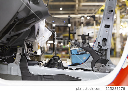 Industrial production of car automobiles. Plant for assembling modern cars on an assembly line. Industry, production, industry concept. Industrial production of car automobiles. Plant for assembling modern cars on an assembly line. Industry, production, industry concept. 115285276