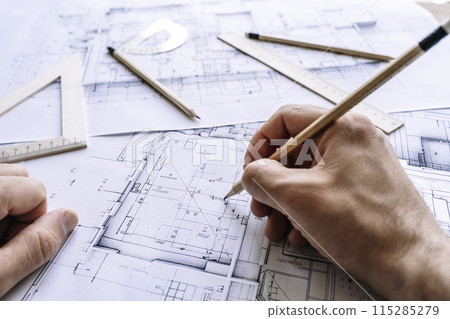 Architectural engineering design plan drawing on the table. Architect's work on table in studio. Construction design and plan 115285279