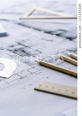 Architectural engineering design plan drawing on the table. Architect's work on table in studio. Construction design and plan 115285280