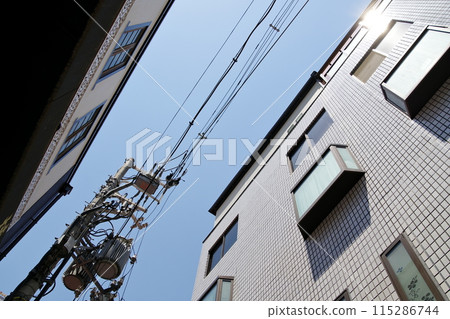 Scenery of a residential area with electric wires Scenery of a residential area with electric wires 115286744