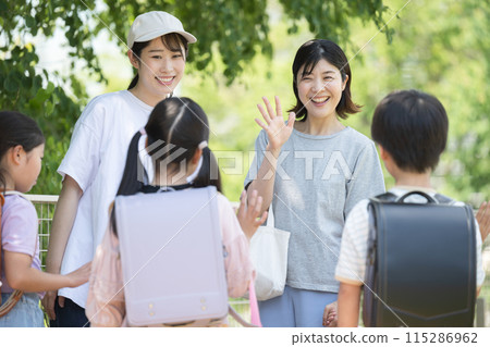 Elementary school students and their parents, the morning school group picking up and dropping off their children. Have a great day today! No faces of the children 115286962