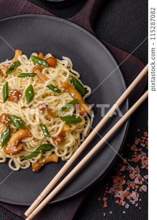 Delicious Asian cuisine dish with rice noodles, peppers, mushrooms and spices 115287082