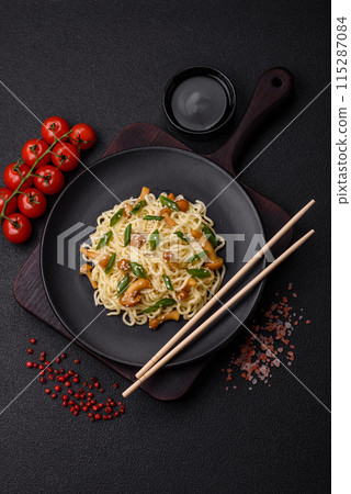 Delicious Asian cuisine dish with rice noodles, peppers, mushrooms and spices Delicious Asian cuisine dish with rice noodles, peppers, mushrooms and spices 115287084