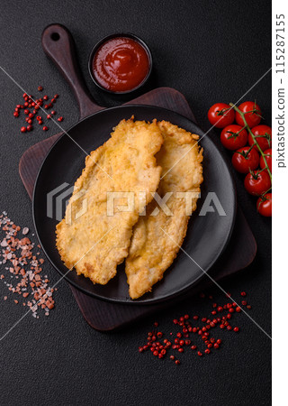 Delicious juicy chicken chops in batter with salt, spices and herbs 115287155