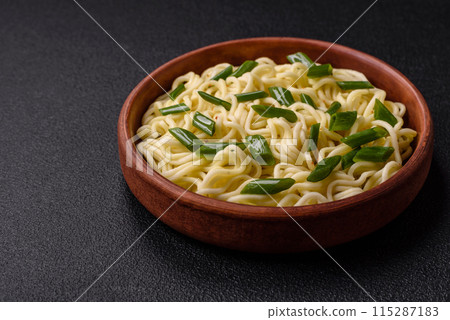 Delicious Asian cuisine dish with rice noodles, peppers, mushrooms and spices Delicious Asian cuisine dish with rice noodles, peppers, mushrooms and spices 115287183