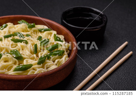 Delicious Asian cuisine dish with rice noodles, peppers, mushrooms and spices Delicious Asian cuisine dish with rice noodles, peppers, mushrooms and spices 115287185
