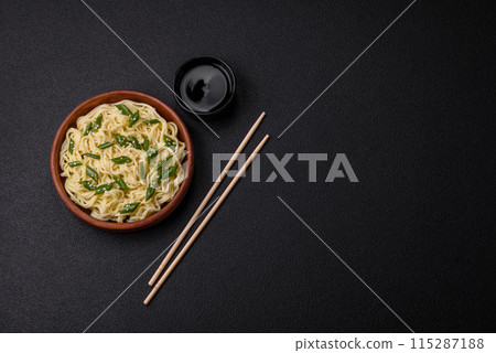 Delicious Asian cuisine dish with rice noodles, peppers, mushrooms and spices Delicious Asian cuisine dish with rice noodles, peppers, mushrooms and spices 115287188