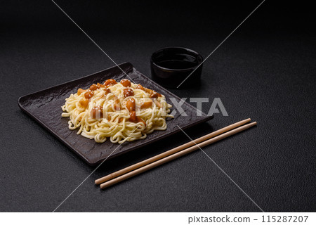 Delicious Asian cuisine dish with rice noodles, peppers, mushrooms and spices Delicious Asian cuisine dish with rice noodles, peppers, mushrooms and spices 115287207