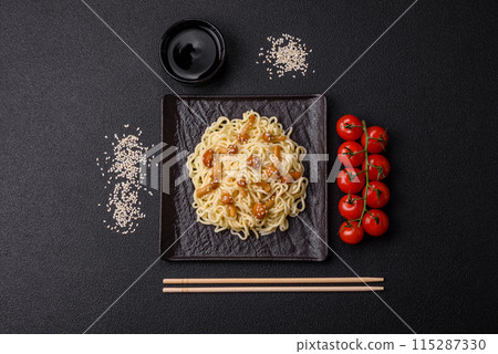 Delicious Asian cuisine dish with rice noodles, peppers, mushrooms and spices Delicious Asian cuisine dish with rice noodles, peppers, mushrooms and spices 115287330