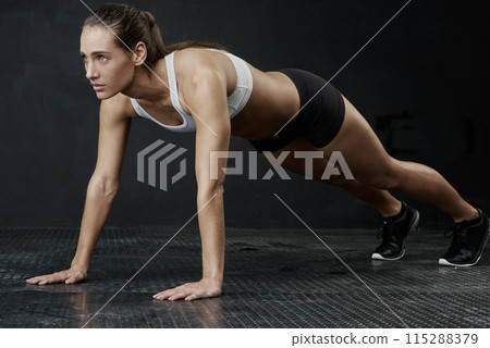 Sports, fitness and woman in push up for strength, power and endurance training in studio. Female person or athlete and health with cardio workout, strong body and exercise goal or challenge Sports, fitness and woman in push up for strength, power and endurance training in studio. Female person or athlete and health with cardio workout, strong body and exercise goal or challenge 115288379