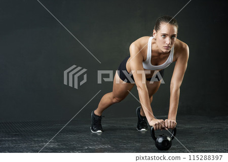 Fitness, kettle bell and space with sports woman in studio on dark background for physical workout. Exercise, mindset and weights with serious athlete training body in health club for challenge 115288397