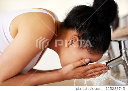 Girl, bathroom and tap for washing face, skincare and beauty for morning routine or wellness in home. Woman, sink or female person cleaning with water in house for natural facial treatment in basin 115288745