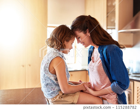 Forehead, mother and girl in home for love with connection, affection and comfort with safety or security on mothers day. Mom, daughter and bonding together in kitchen for support, moments and care. Forehead, mother and girl in home for love with connection, affection and comfort with safety or security on mothers day. Mom, daughter and bonding together in kitchen for support, moments and care. 115288782