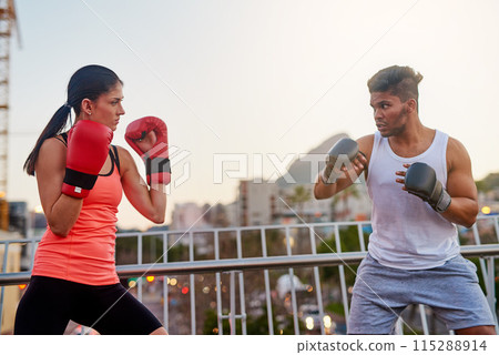 Boxing, people and outdoor training in city, trainer and fitness or workout for strong power. Couple, town bridge and together for exercise and gloves for practice, teaching and coach for punch 115288914