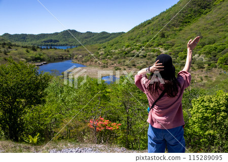Mount Akagi in early summer: A woman enjoying the view from Torii Pass Mount Akagi in early summer: A woman enjoying the view from Torii Pass 115289095