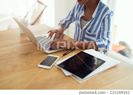 Woman, laptop and paperwork for work from home for blog, social media and email in at desk. African female journalist, typing and research for networking, newspaper article and online magazine 115289161