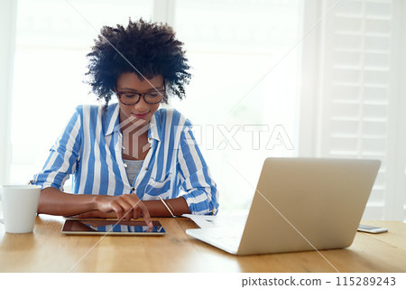 Woman, technology and research at desk for blog, social media and email in apartment. African female journalist, networking and working from home for typing, newspaper article and online magazine 115289243