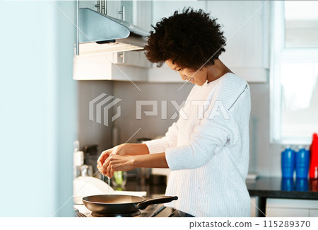 Black woman, egg and heat on stove in home, frying pan and meal preparation in kitchen. Female person, apartment and nutrition in food, diet and cooking for cuisine on weekend for dinner routine Black woman, egg and heat on stove in home, frying pan and meal preparation in kitchen. Female person, apartment and nutrition in food, diet and cooking for cuisine on weekend for dinner routine 115289370