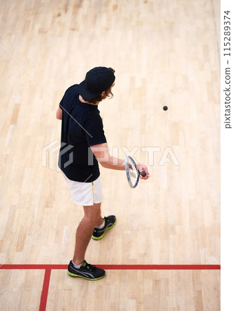 Man, squash player or top view of racket to hit ball in indoor court game for fitness, cardio training or exercise. Workout, wellness or athlete playing sports on floor with motion, action or power Man, squash player or top view of racket to hit ball in indoor court game for fitness, cardio training or exercise. Workout, wellness or athlete playing sports on floor with motion, action or power 115289374