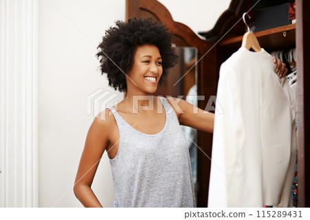 Black woman, smile and clothes choice at wardrobe in home, getting ready and morning preparation. Closet, fashion and girl with decision in bedroom, fabric and think of textile for dressing in house 115289431