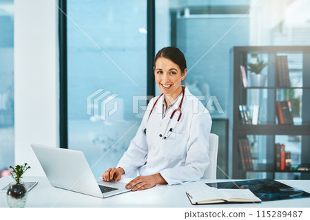 Doctor, woman and portrait in office with laptop, medical research and planning hospital schedule. Female person, smile and confident for healthcare, cardiologist and clinic website for medicare 115289487