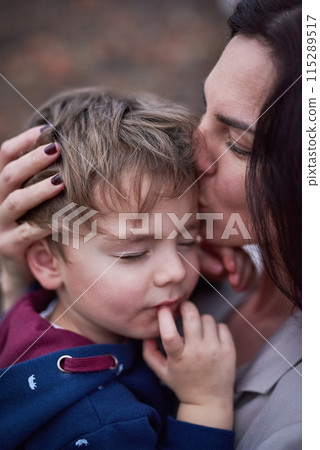 Mother, son and kiss or hug with love for bonding, comfort and security with healthy relationship. Family, woman and boy child with embrace for affection, care and trust with motherhood and parenting 115289517