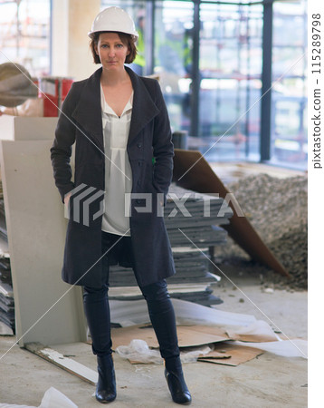 Portrait, helmet and woman in site for construction, affirmative action and inspector visit in building. Contractor, female employee and inspection of property, development and report for company 115289798
