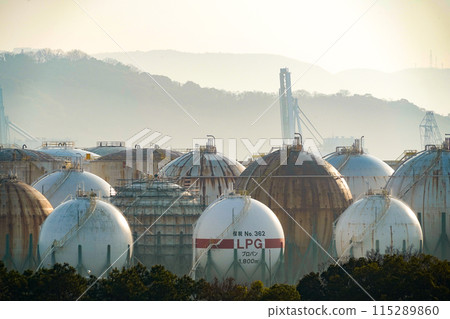 Gas tanks lit by the morning sun 115289860