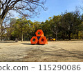Red block sculpture in the park 115290086
