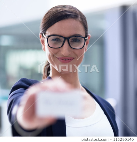 Smile, woman and portrait with business card in office for information, contact or about us in workplace. Female agent, confident and hold up sign in agency for details, recruitment or get in touch 115290140