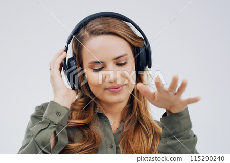 Woman, studio or dancing with headphones and hand for subscription, streaming or music with happiness. Female student or celebrate on backdrop with audio for podcast, happy with sound in California Woman, studio or dancing with headphones and hand for subscription, streaming or music with happiness. Female student or celebrate on backdrop with audio for podcast, happy with sound in California 115290240