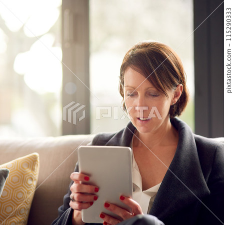 Corporate woman, tablet and work from home on couch for email, conversation and communication. Female person, technology and online in morning for networking, streaming and watch series in apartment 115290333