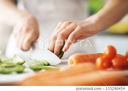 Cooking, hands and knife for vegetables on kitchen counter in home for diet, health or nutrition. Chef, food recipe and natural ingredients with person preparing organic meal for dinner or wellness Cooking, hands and knife for vegetables on kitchen counter in home for diet, health or nutrition. Chef, food recipe and natural ingredients with person preparing organic meal for dinner or wellness 115290454