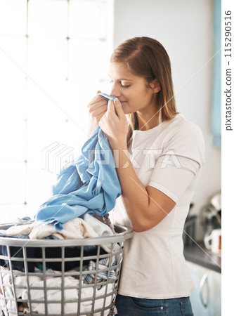Laundry, fresh and woman smelling clothes after cleaning, housework and washing material in morning. Chores, housekeeping and cleaner or female person with basket, fabric or soft cotton in home 115290516