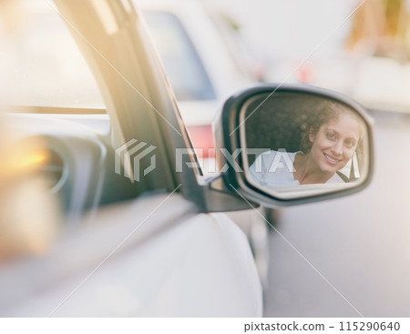 Young, woman and driving with side mirror in car for road trip, travel or commute for holiday. Female person, check and reflection in glass for safety on vacation, smile or happiness for journey 115290640