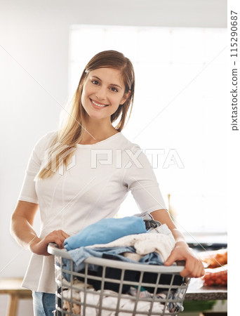 Portrait, home and woman with a laundry basket, smile and cleaning with chores, housekeeping and hygiene. Face, female person or cleaner with dirty clothes, apartment and washing fabric with service 115290687