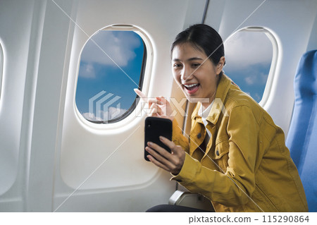 happy excited asian women waved to greet friends using a smartphone in airplane. 115290864
