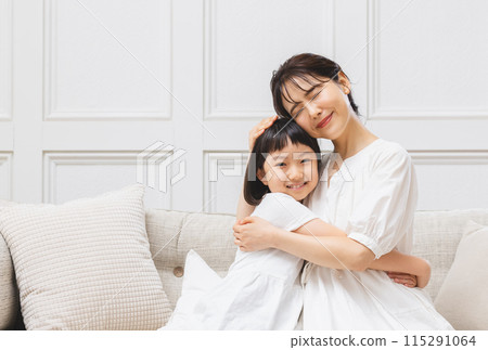 Mother and daughter hugging Mother and daughter hugging 115291064