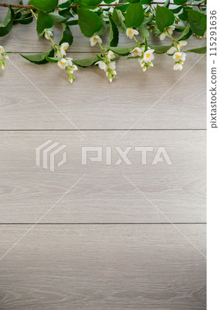 wooden light background with white jasmine flowers 115291636