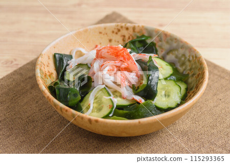 Cucumber, crab sticks and wakame seaweed in vinegar 115293365