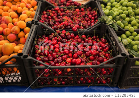 Ripe cherries at street market. Fresh cherries with stems Ripe cherries at street market. Fresh cherries with stems 115293455